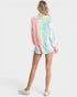 Person wearing a tie-dye shirt on a white background