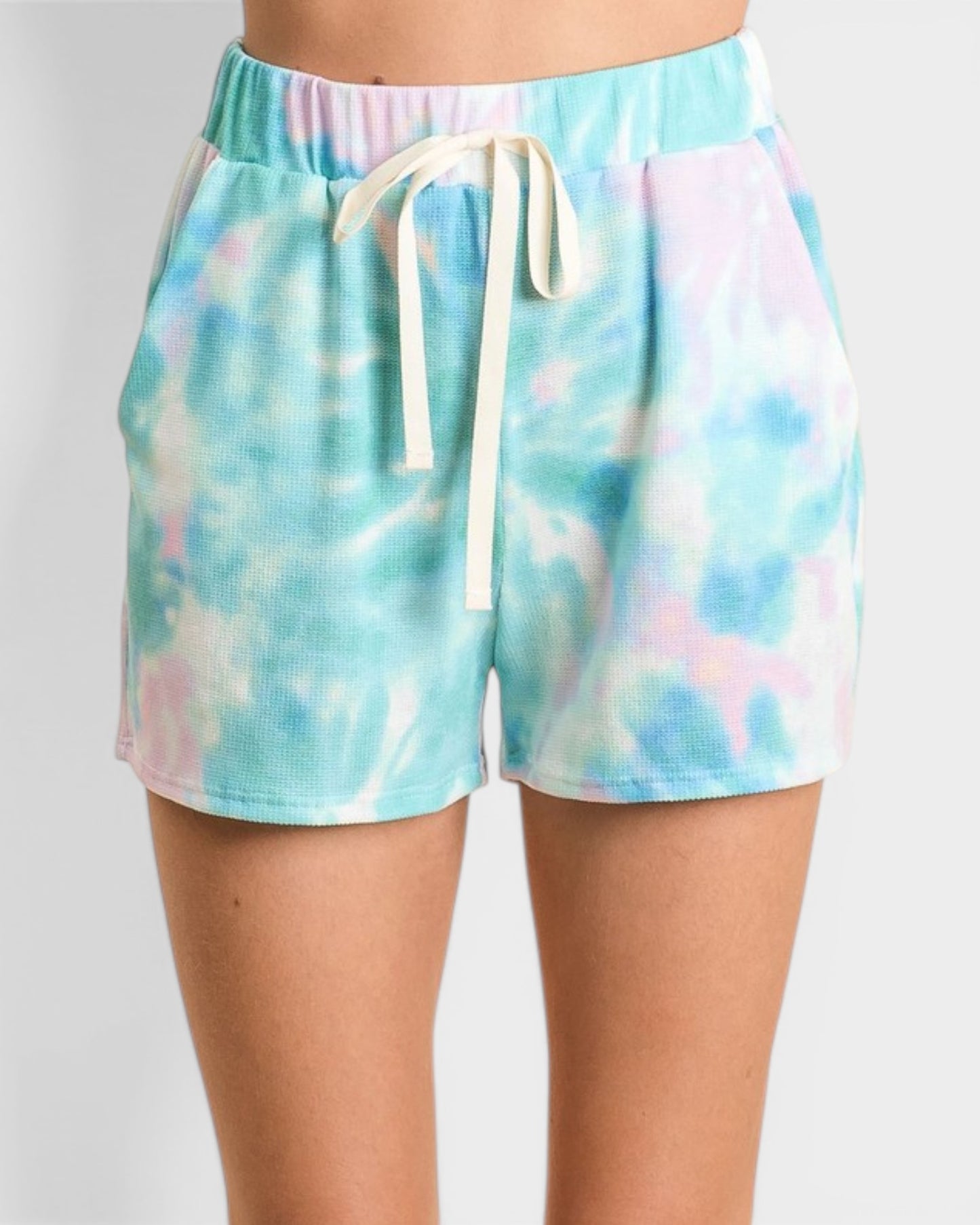 Tie-dye shorts with a drawstring on a plain background