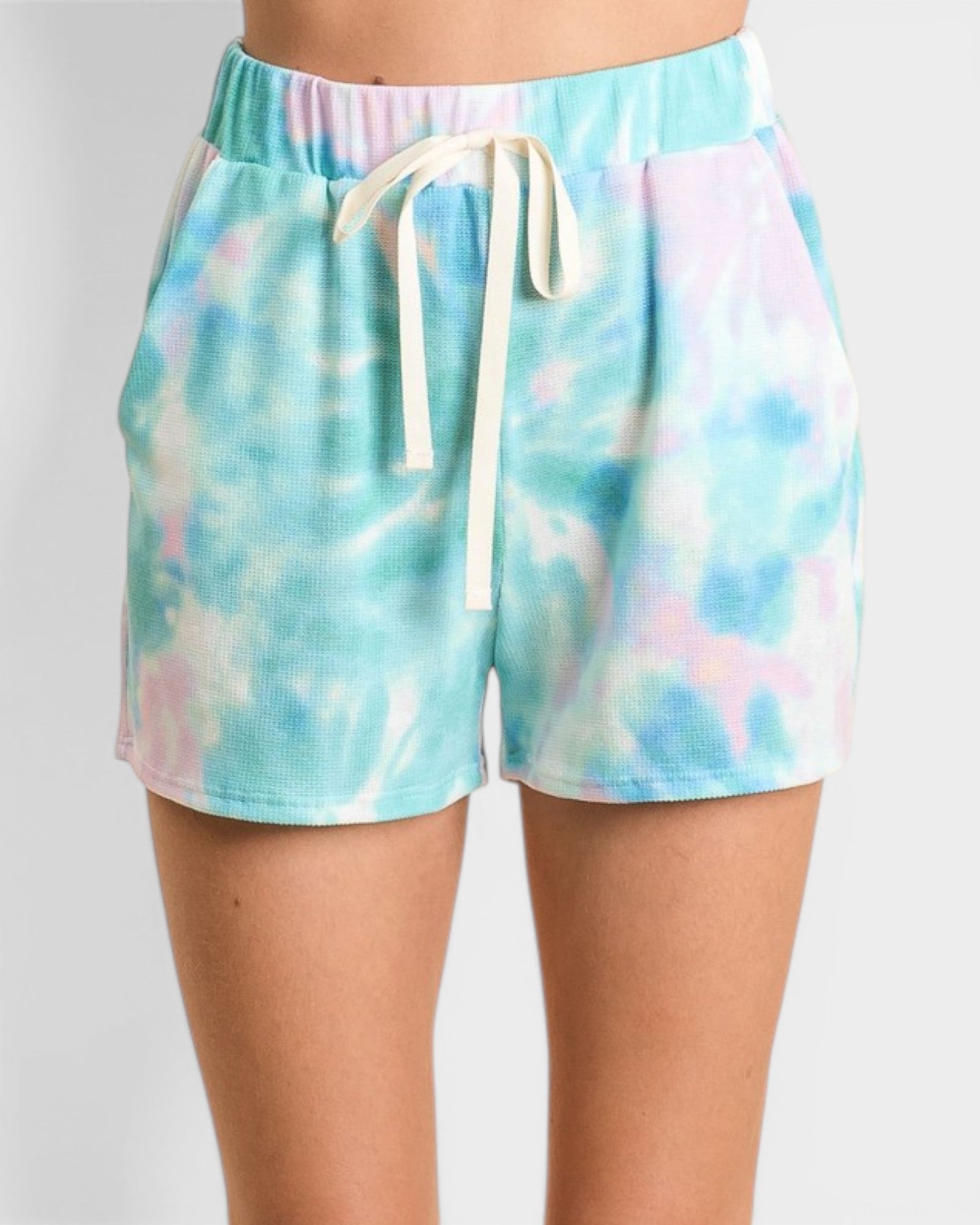 Tie-dye shorts with a drawstring on a plain background