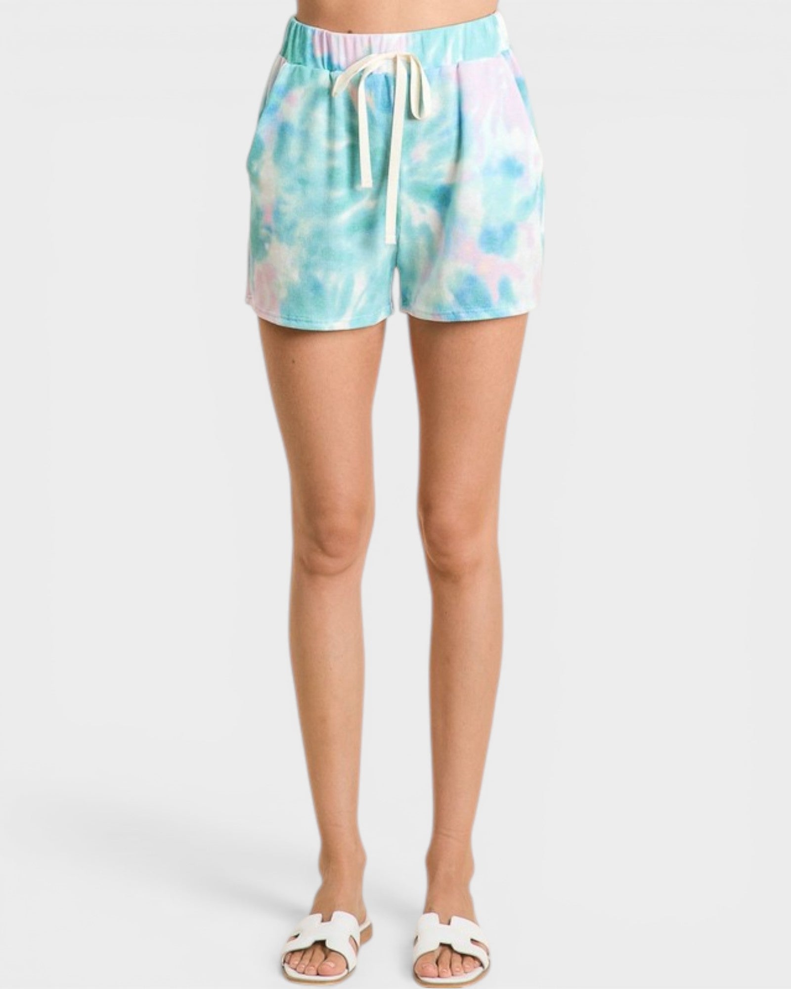 Tie-dye shorts worn by a person on a white background