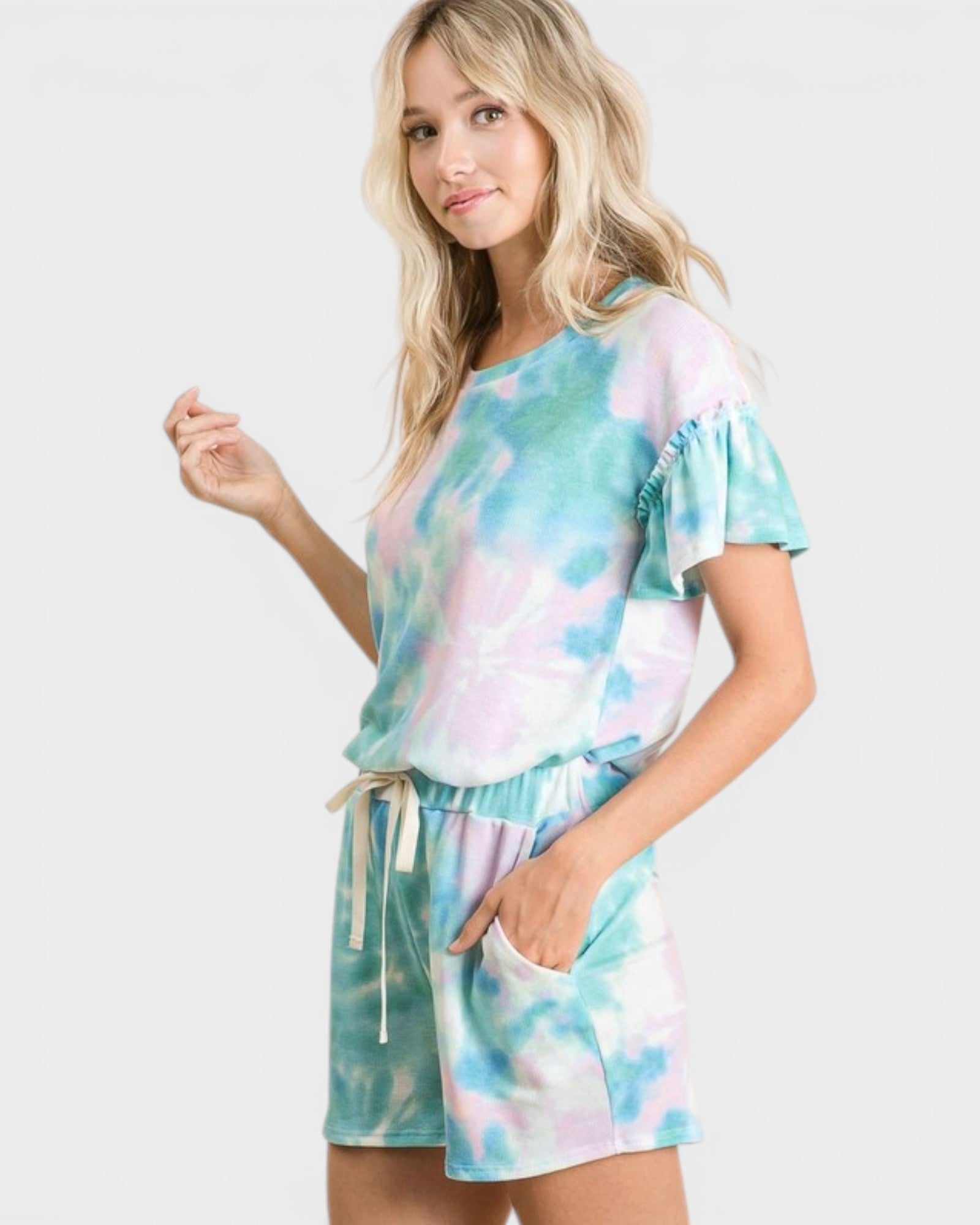 Woman wearing a tie-dye outfit on a white background