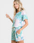 Woman wearing a tie-dye outfit on a white background