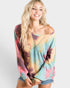 Woman wearing a tie-dye shirt with a plain background