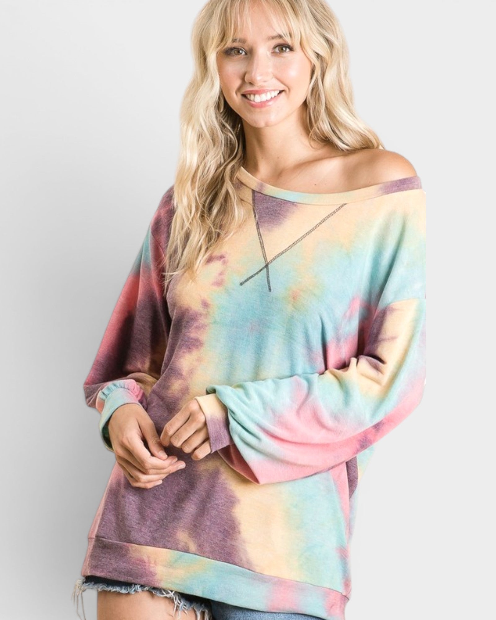 Woman wearing a tie-dye sweater against a plain background