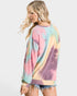 Woman wearing a tie-dye sweater with a plain background