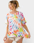 Woman wearing a colorful tie-dye shirt on a white background