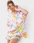 Woman wearing a colorful tie-dye shirt against a plain background