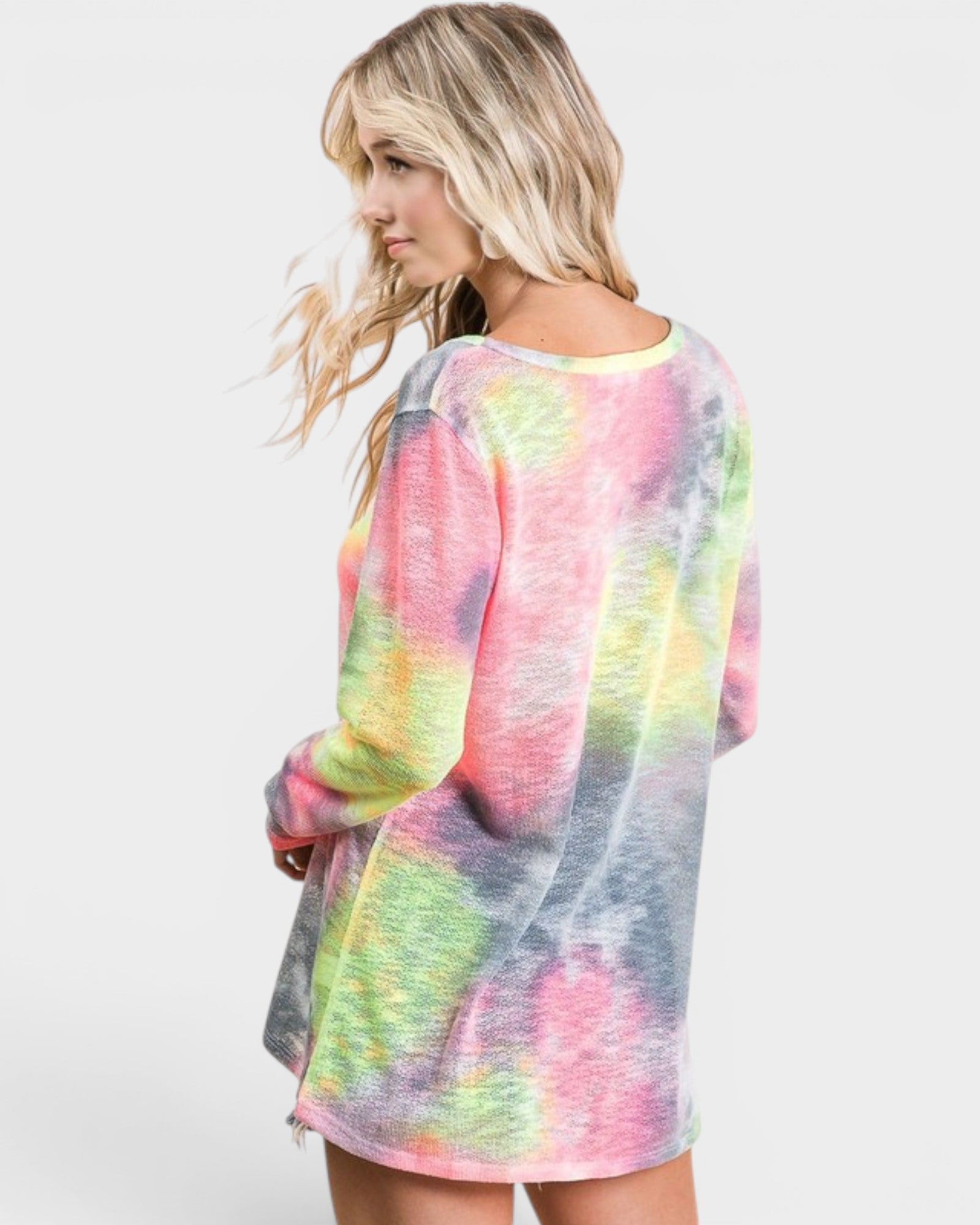 Woman wearing a colorful tie-dye shirt on a white background