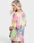 Woman wearing a colorful tie-dye shirt on a white background