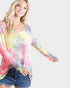 Woman wearing a colorful tie-dye long-sleeve shirt on a white background