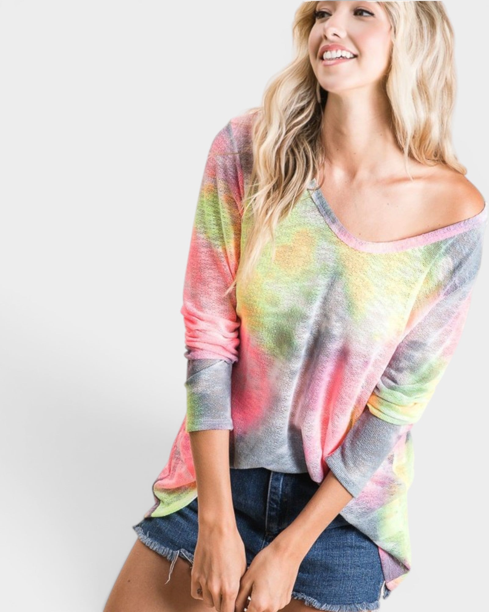 Woman wearing a colorful tie-dye shirt on a white background