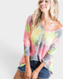 Woman wearing a colorful tie-dye shirt on a white background