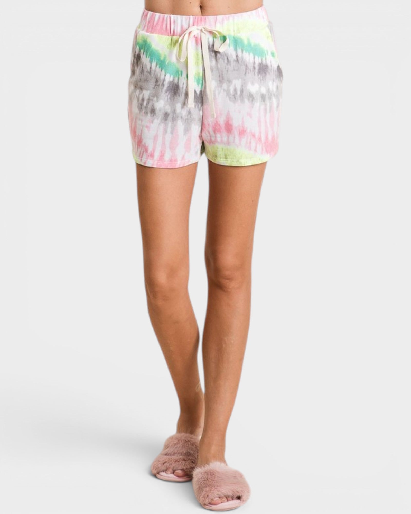 Person wearing tie-dye shorts on a white background