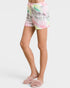 Person wearing colorful tie-dye shorts on a white background
