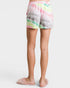 Person wearing colorful tie-dye shorts on a white background