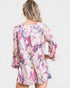Woman wearing a colorful floral blouse on a white background