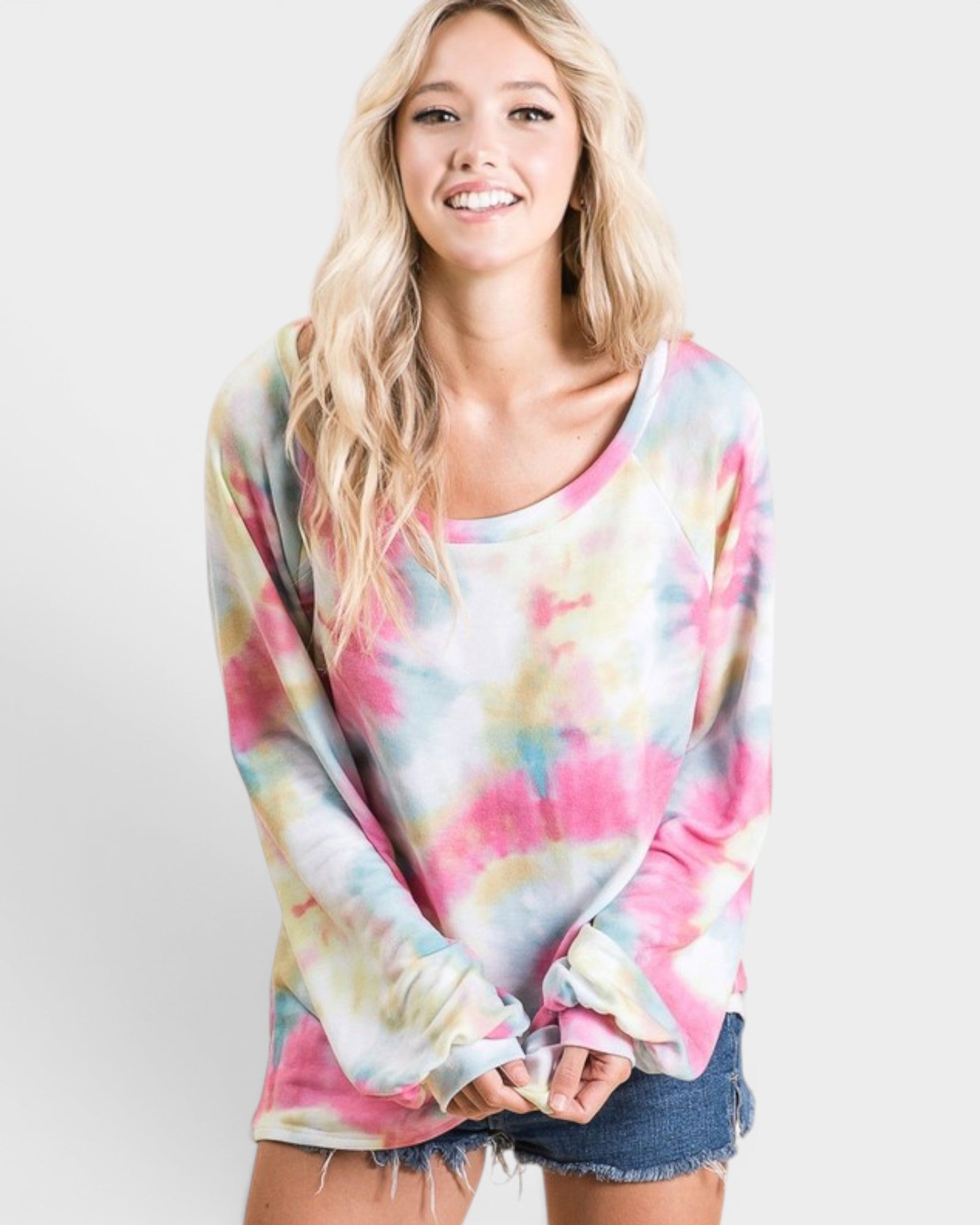 Woman wearing a colorful tie-dye sweater on a white background