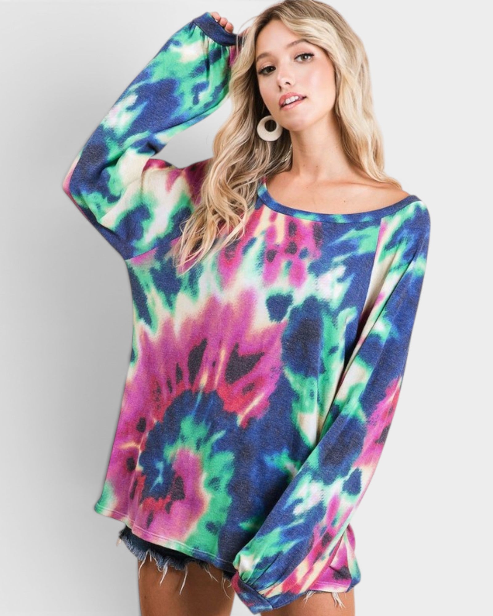 Woman wearing a colorful tie-dye long-sleeve top on a white background