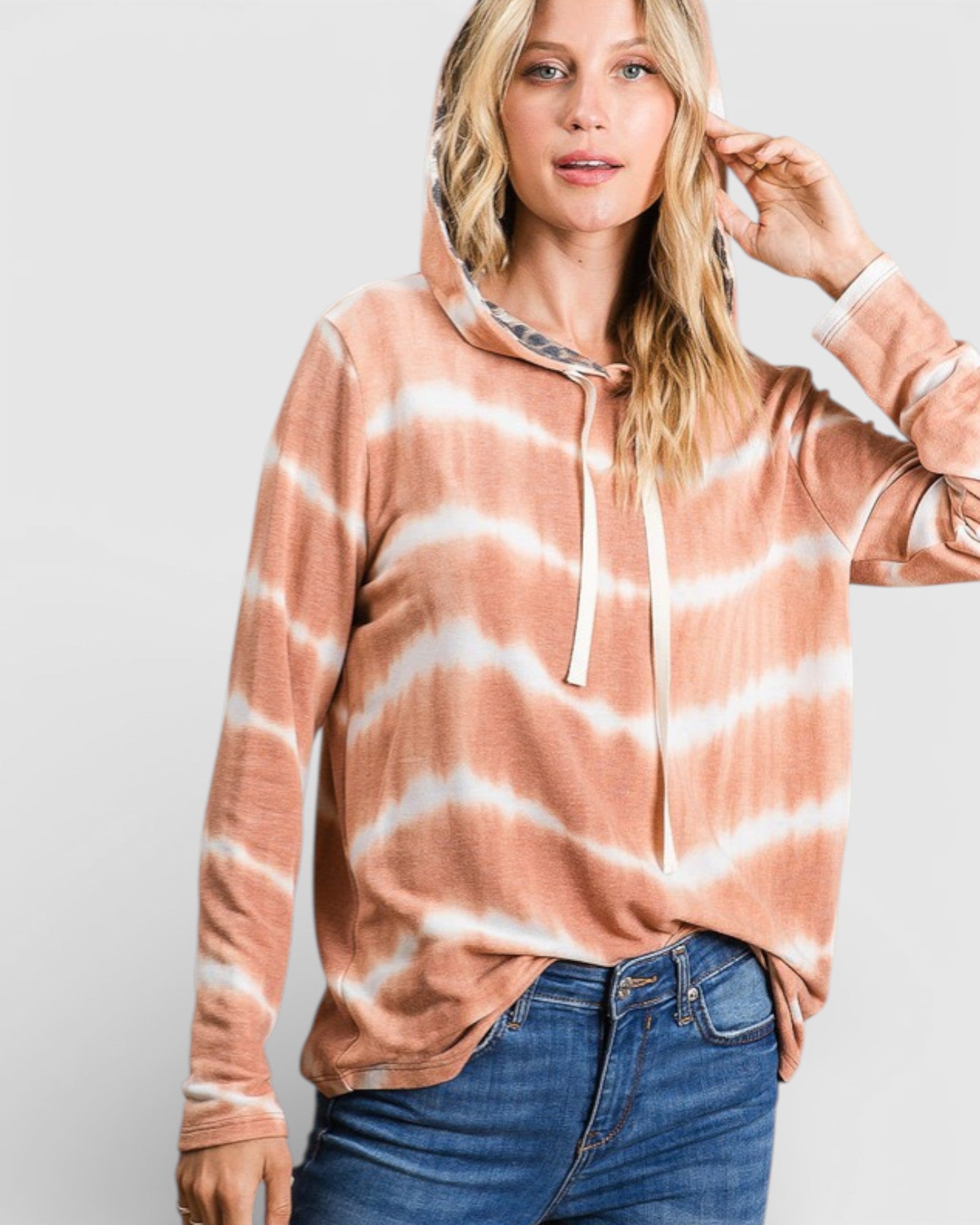 Woman wearing a tie-dye hoodie with a white background