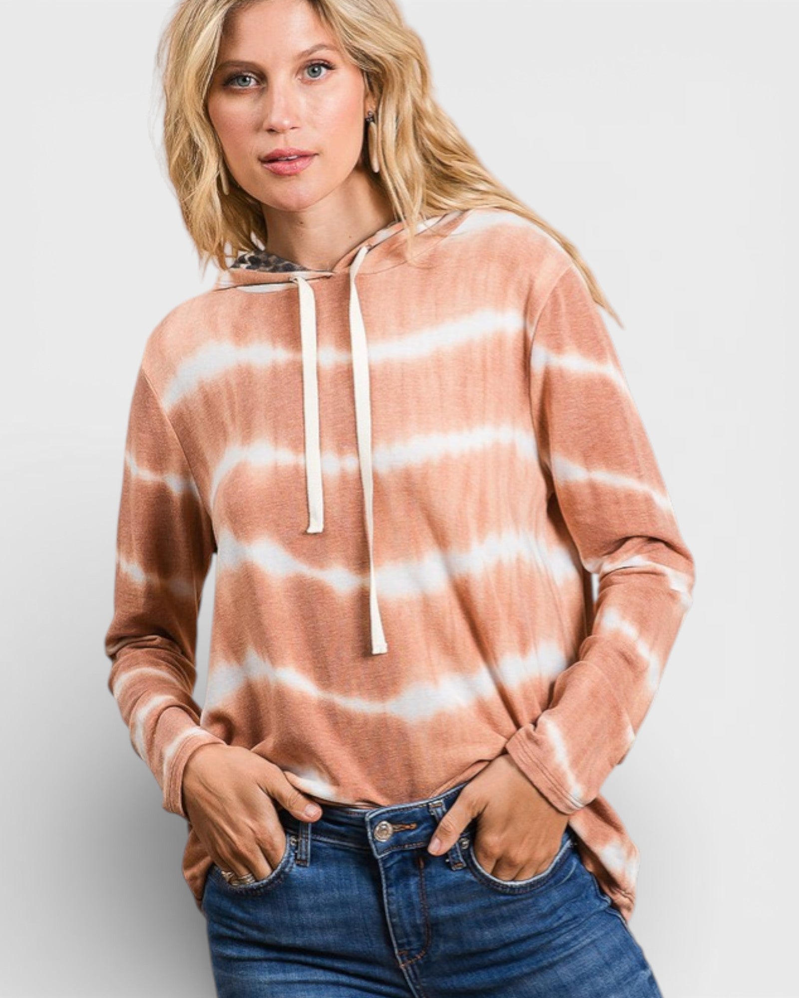 Woman wearing a tie-dye hoodie with a plain background