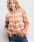 Woman wearing a tie-dye hoodie with a plain background