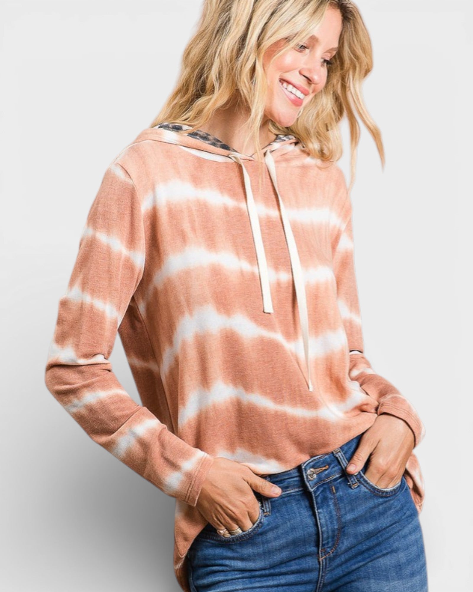 Woman wearing a tie-dye hoodie with a white background