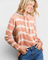 Woman wearing a tie-dye hoodie with a white background