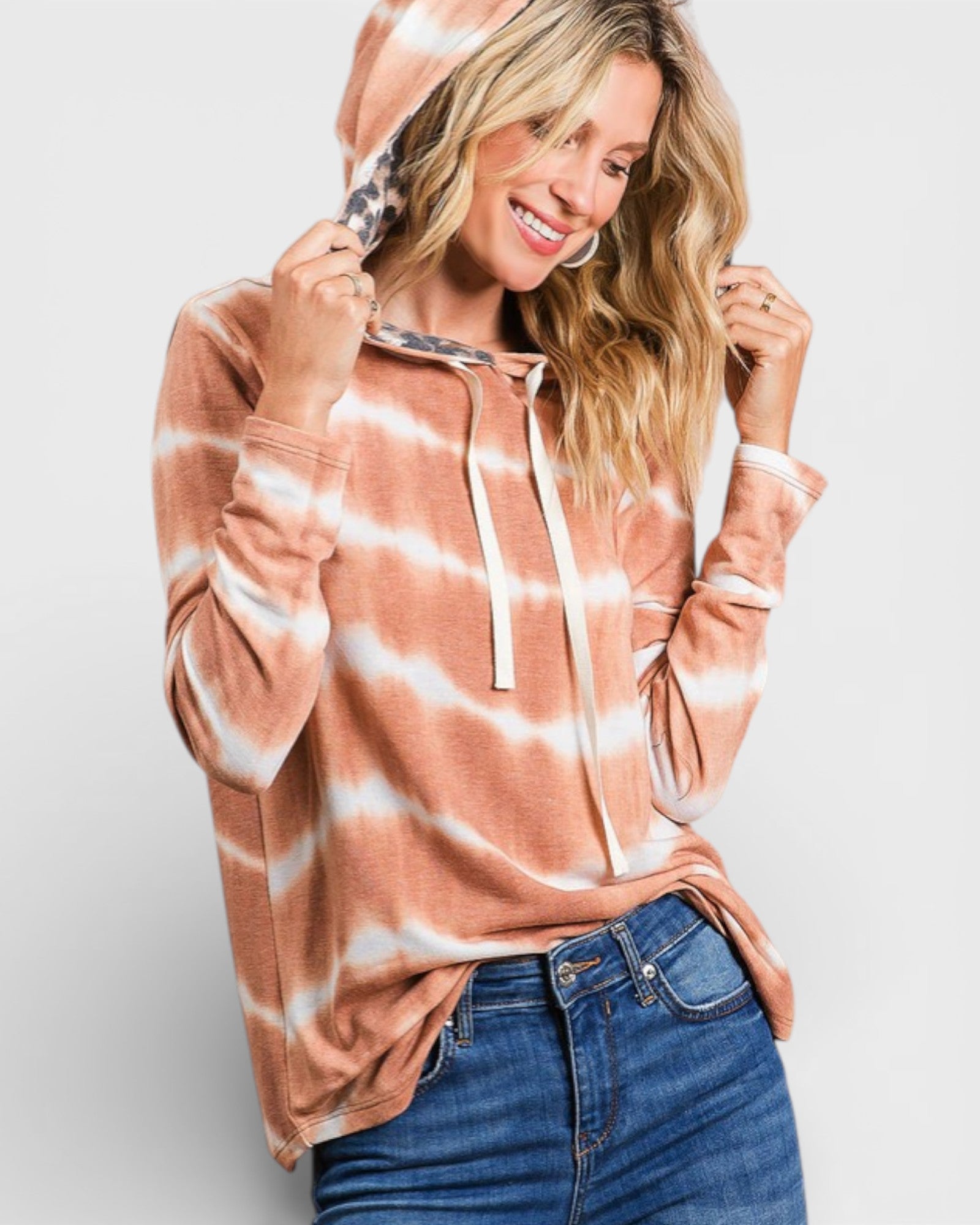 Woman wearing a tie-dye hoodie with a white background