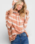 Woman wearing a tie-dye hoodie with a white background