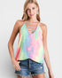 Woman wearing a tie-dye tank top with strappy details on a plain background