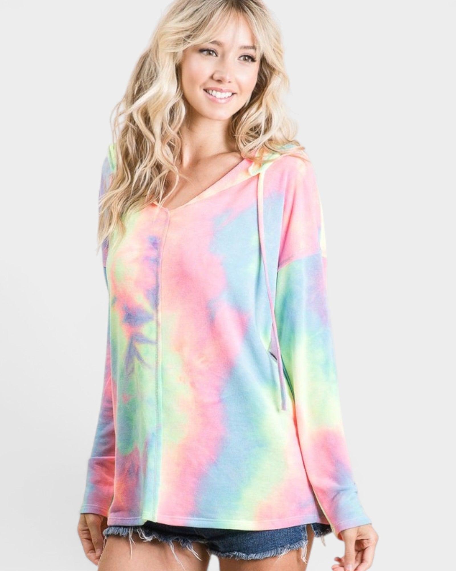 Woman wearing a colorful tie-dye hoodie on a white background