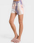 Tie-dye shorts worn by a person on a white background