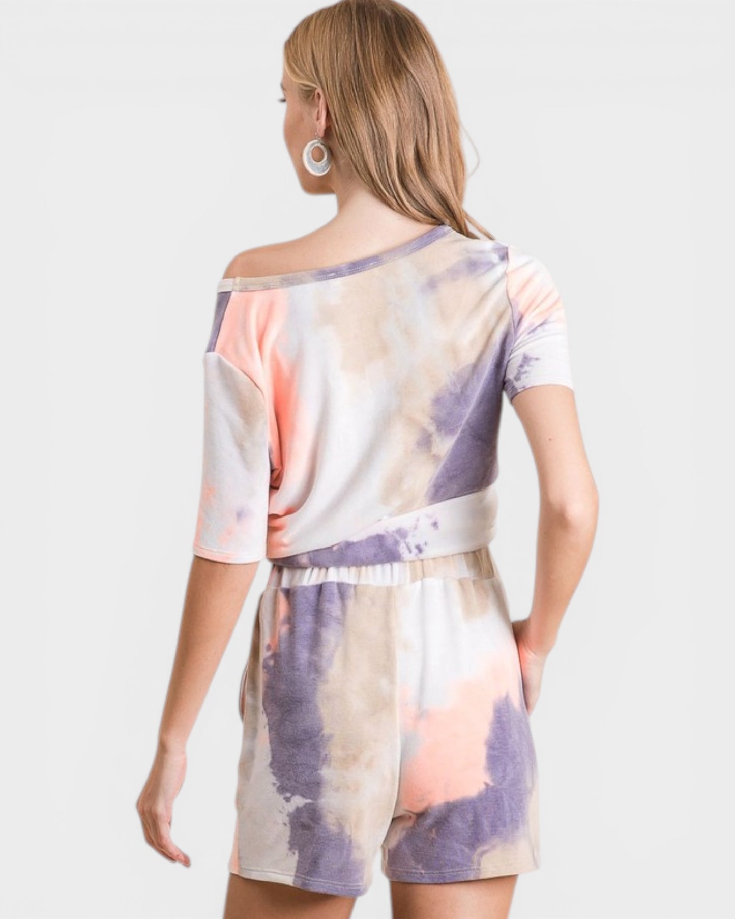 Woman wearing a tie-dye dress with a white background