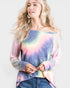 Woman wearing a tie-dye off-shoulder top with a plain background
