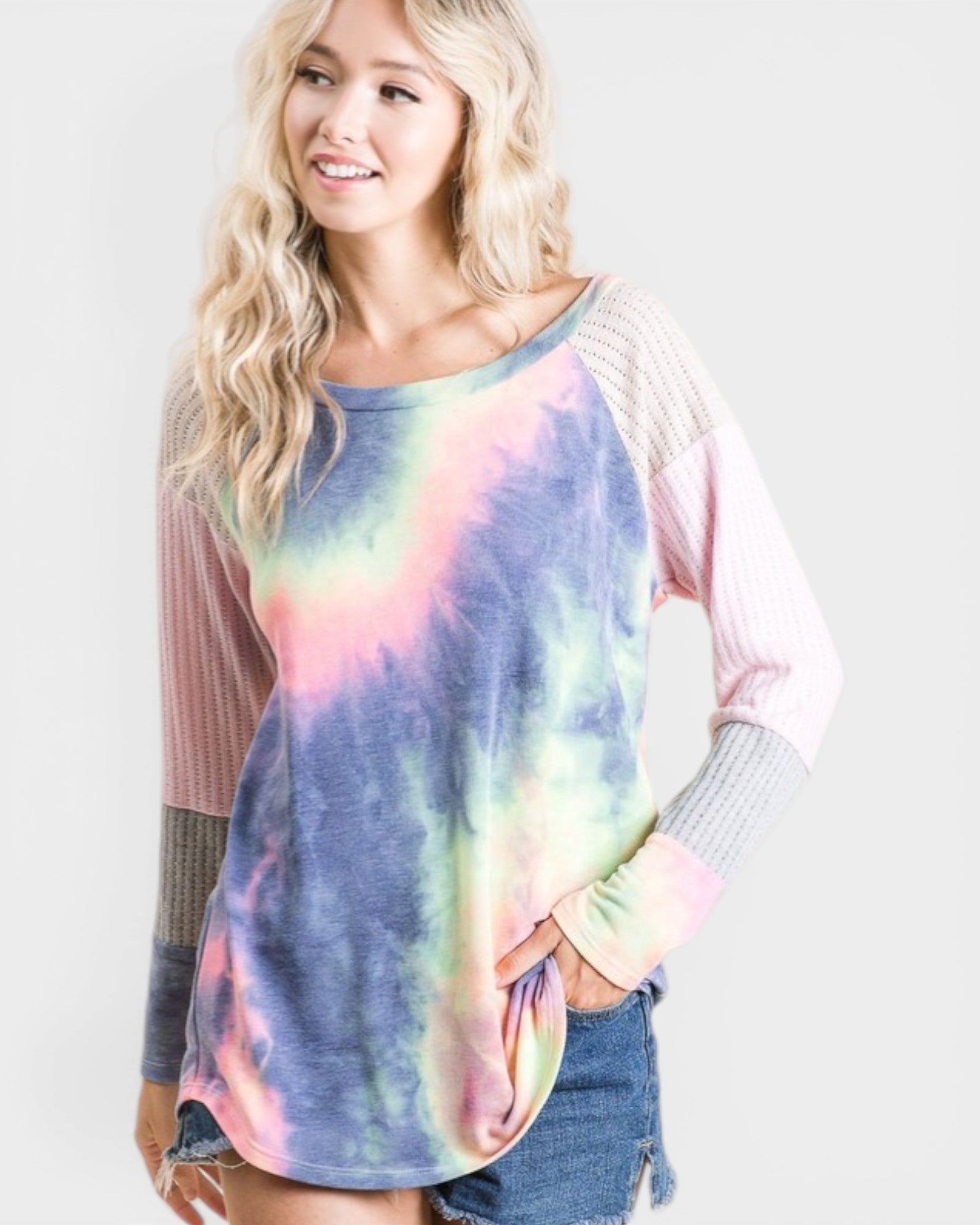Woman wearing a tie-dye shirt with colorful sleeves on a white background