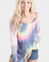 Woman wearing a colorful tie-dye shirt with mesh sleeves on a white background