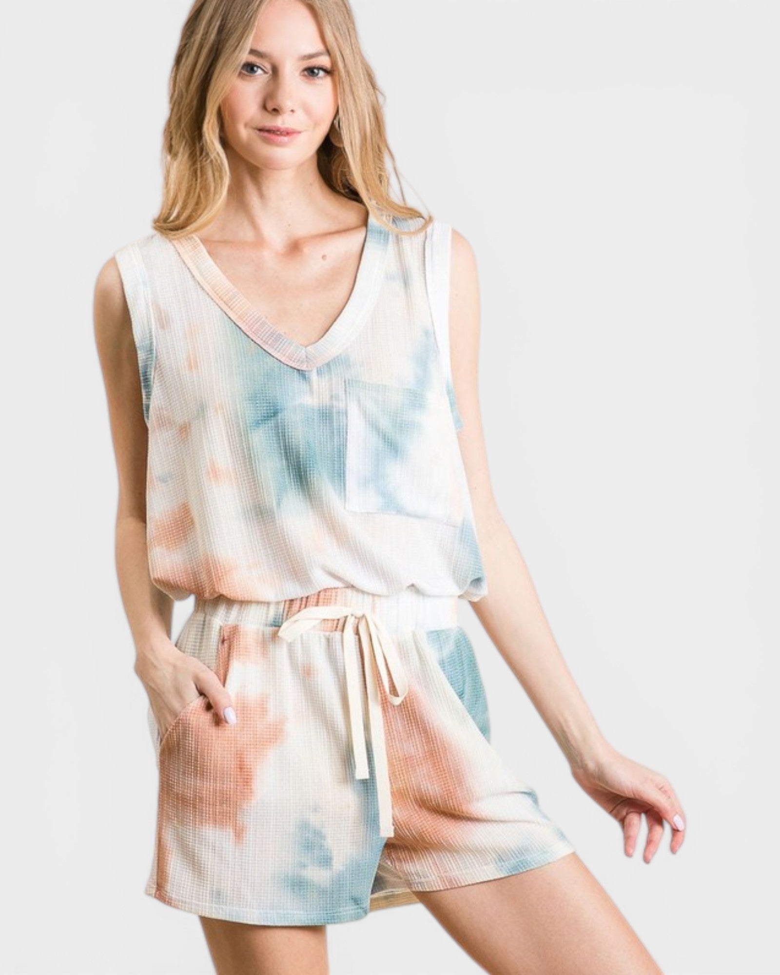 Woman wearing a tie-dye romper on a white background