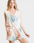 Woman wearing a tie-dye romper on a white background