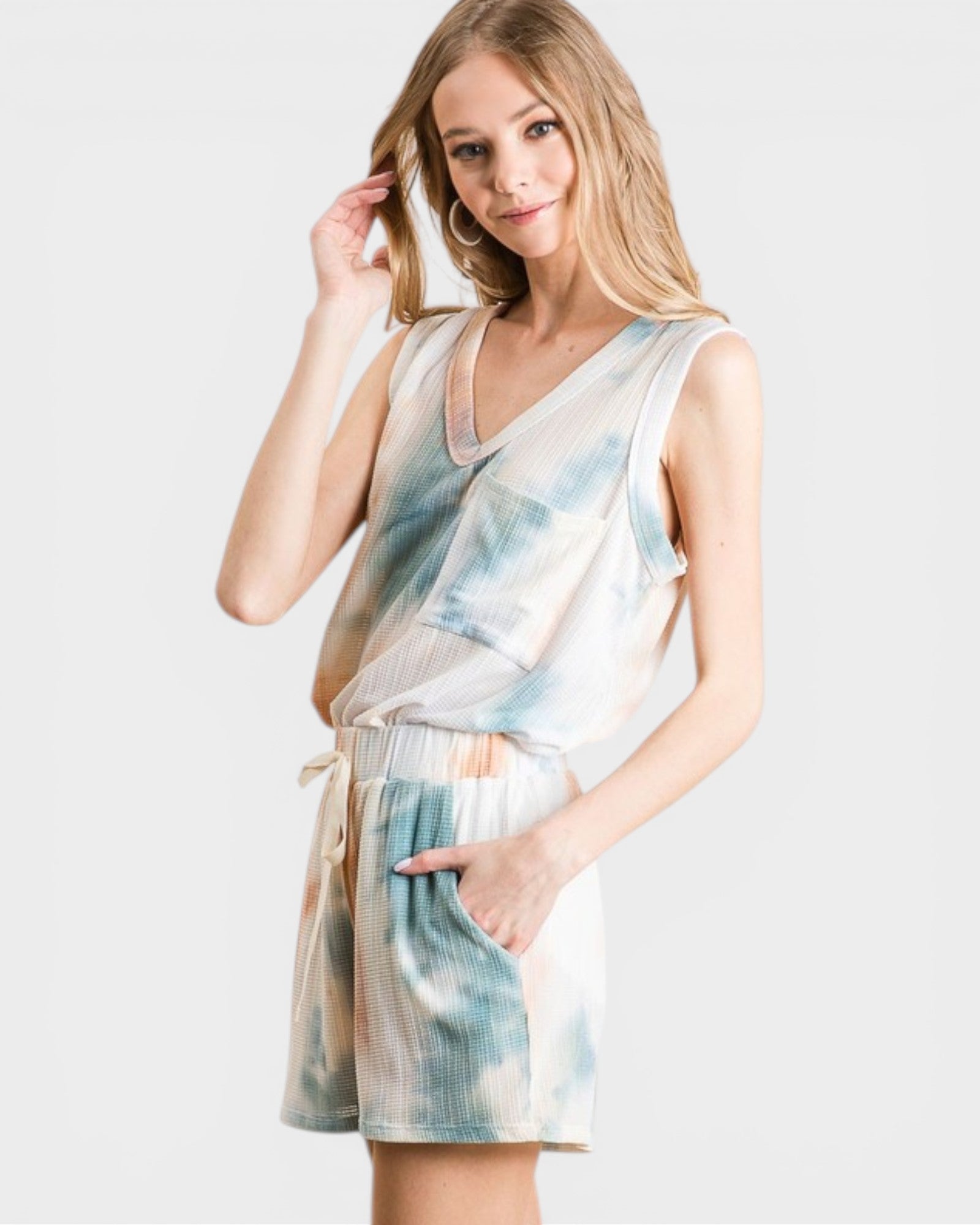 Woman wearing a tie-dye romper on a white background