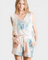 Woman wearing a tie-dye romper on a white background