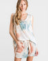 Woman wearing a tie-dye outfit on a white background