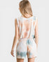 Woman wearing a tie-dye romper on a white background