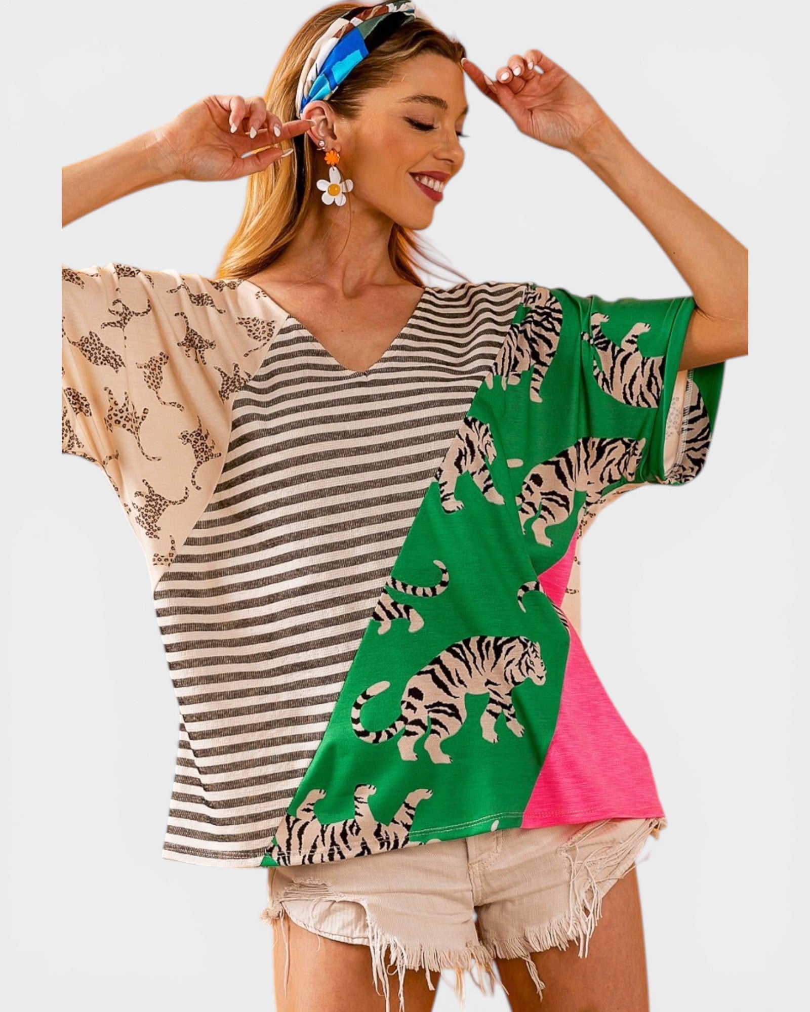 Woman wearing a colorful shirt with tiger pattern on a white background