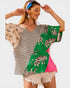 Woman wearing a colorful shirt with tiger pattern on a white background