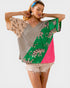 Woman wearing a colorful top with tiger pattern on a white background