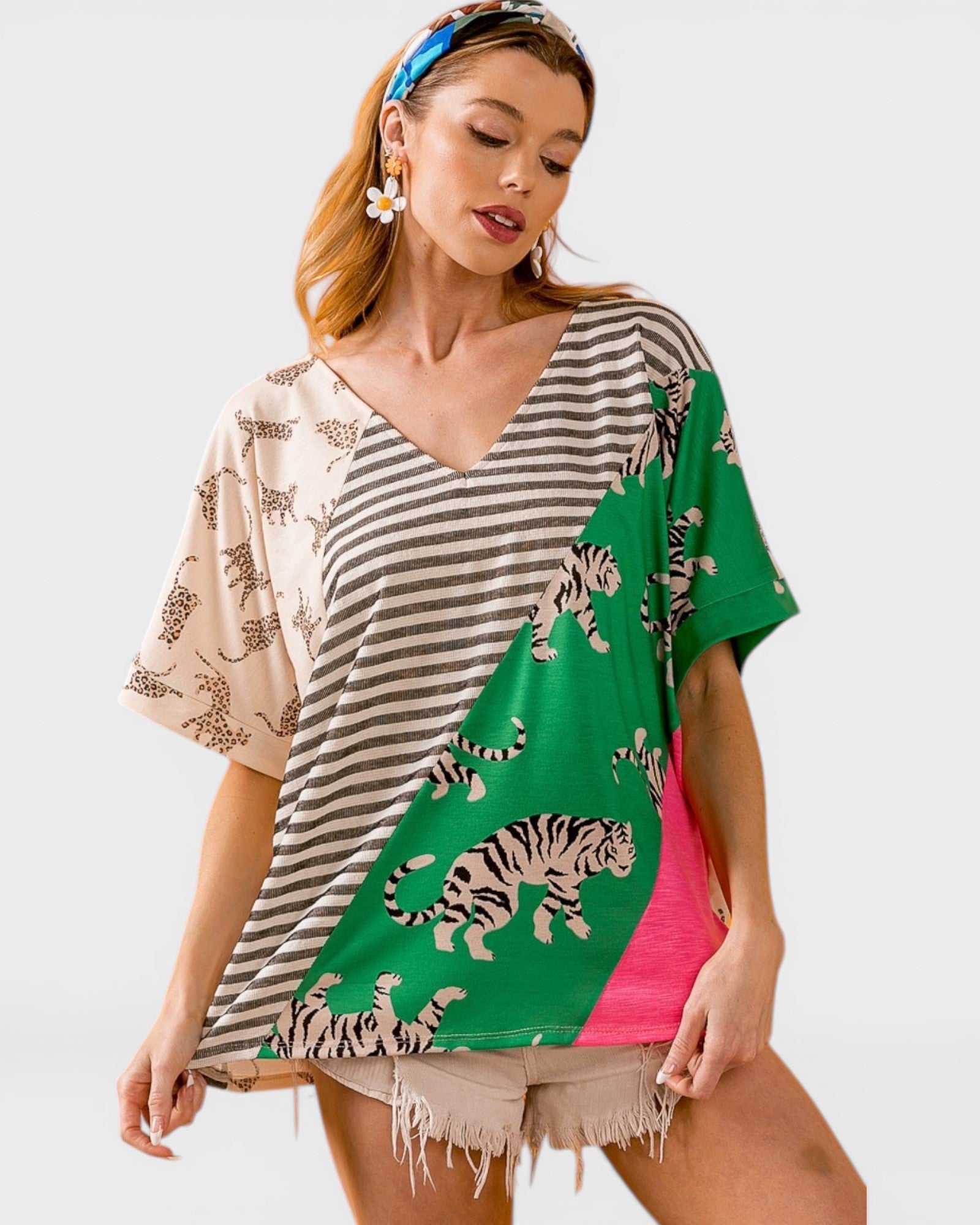 Woman wearing a colorful kimono-style top with tiger designs on a white background
