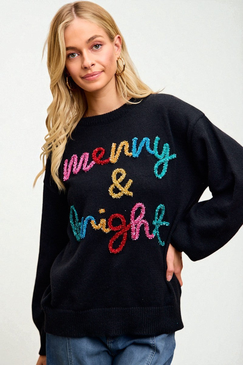 Woman wearing a black sweater with colorful text on a white background