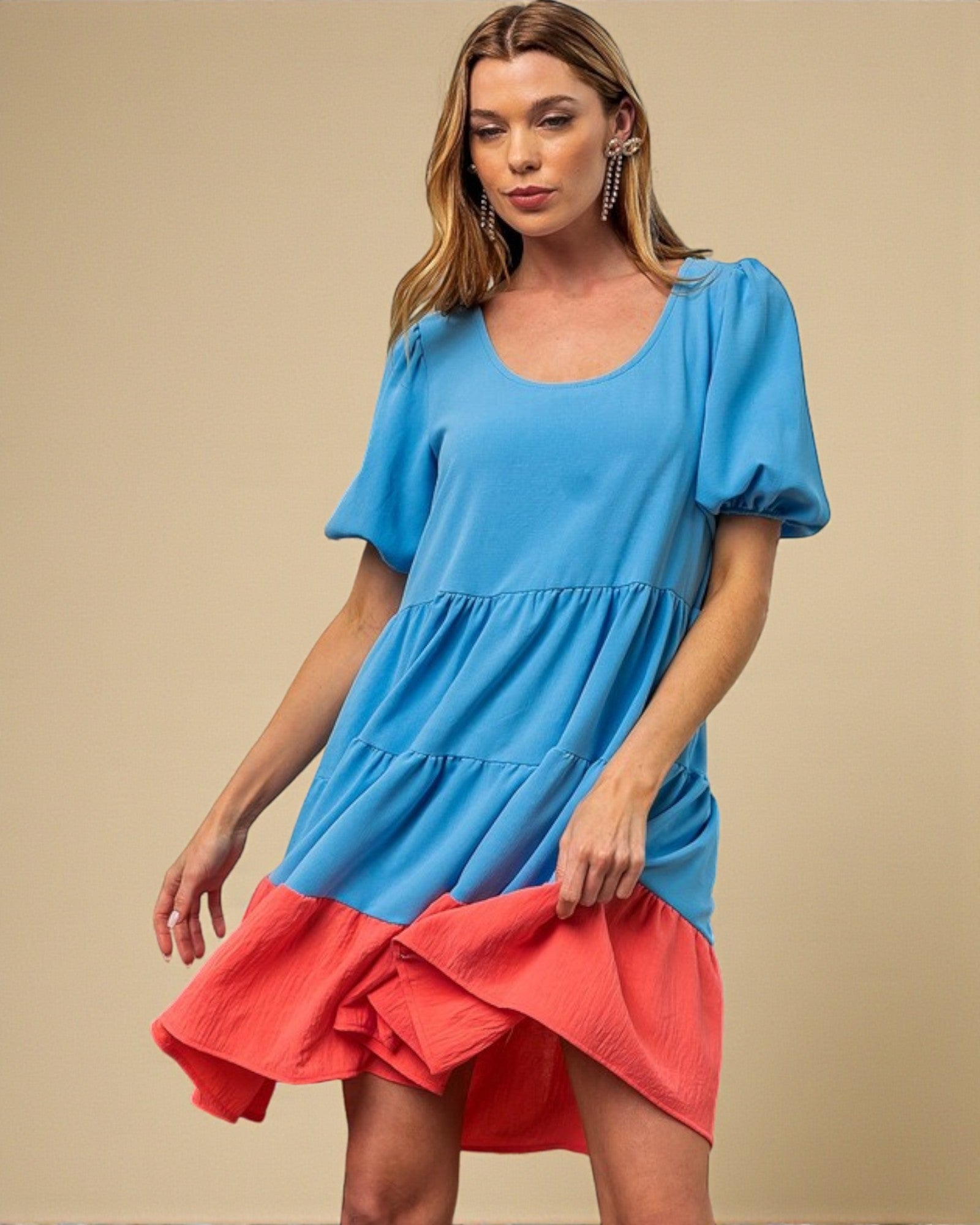 Woman wearing a blue and red dress on a beige background