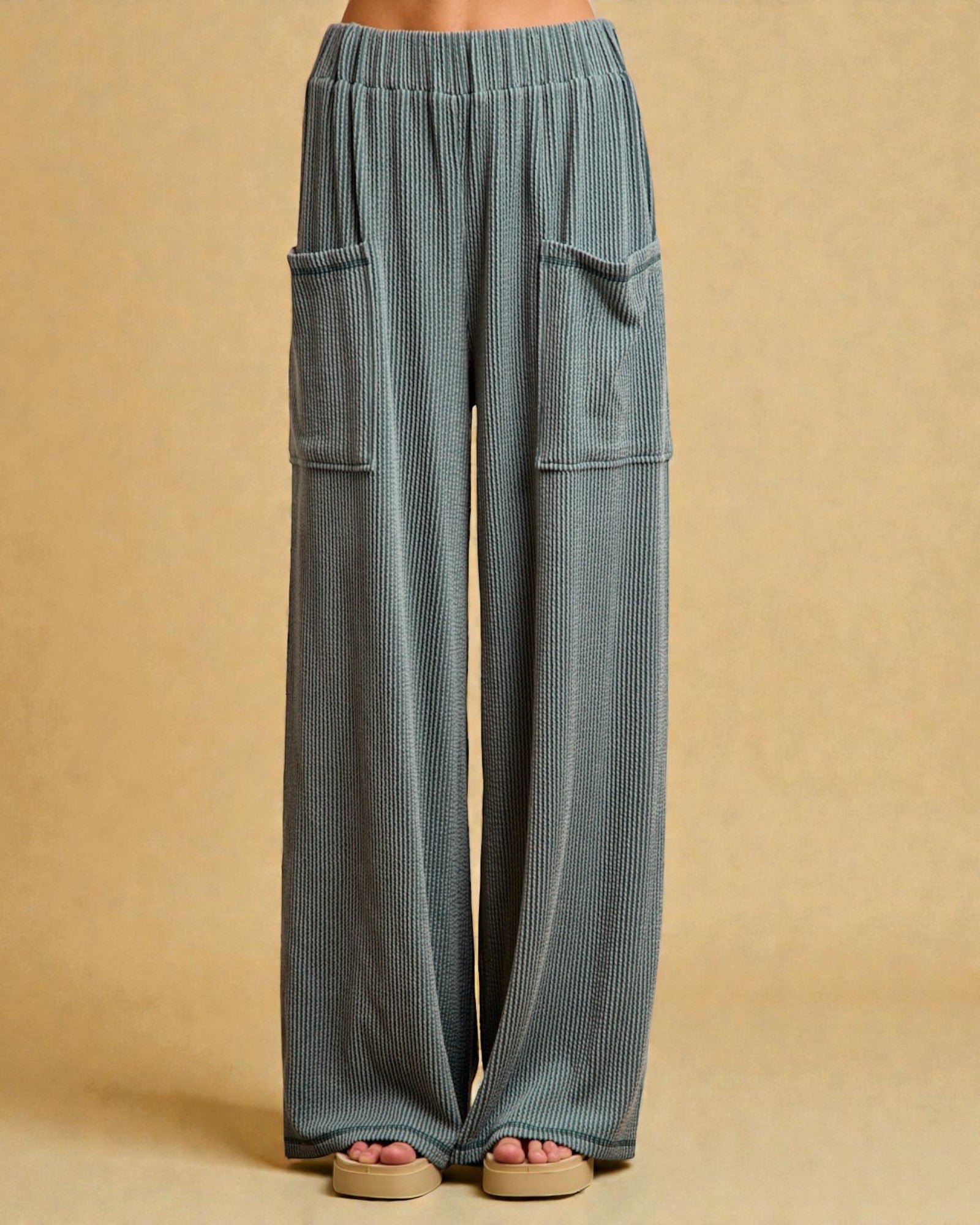Blue corduroy pants with pockets on a beige background