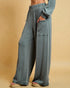 Blue ribbed pants worn by a person on a beige background